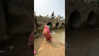 A woman catches fish from a large dam with a hook  amazing fishing in the canal  fishing shorts [upl. by Htennek]