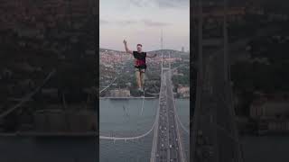 Estonian man walks a slackline set up on Istanbuls Bosphorus Bridge in Turkey [upl. by Oniger953]