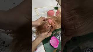 Person is showing how doll heads get their hair [upl. by Anat]