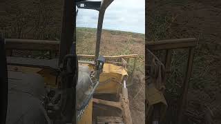 John Deere 750k Raking Up Brush On RootPlowed Ground brush work raking shorts [upl. by Adlitam]