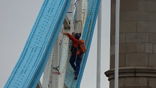 Man climbs Tower Bridge in London to hang a banner [upl. by Alayne893]