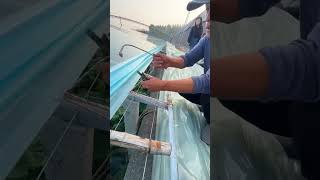 The process of installing the greenhouse film with pliers [upl. by Adnohsirk]