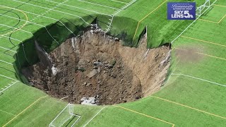 Surveillance video shows moment when 100footwide sinkhole swallows Alton Illinois soccer field [upl. by Aloel]