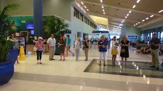 Ukulele Orchestra of St Andrews plays for arriving passengers [upl. by Kip]