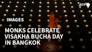 Thailand Buddhist monks light candles on Visakha Bucha Day  AFP [upl. by Aloeda]