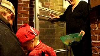 WOMAN SMOKES A CIGARETTE while GIVING OUT TREATS TO CHILDREN ON HALLOWEEN [upl. by Arlyne]