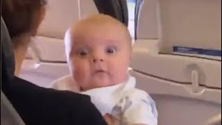 Baby Stares Intently At Airplane Passenger In Hilarious Video [upl. by Fauver996]