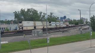 Eastbound CN intermodel cruises past Fort Rouge yards while BNSF 1545 switches the yard 61824 [upl. by Rowena]