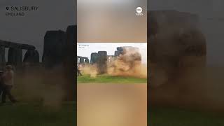 Environmental protesters spray orange material onto Britains Stonehenge news protest stonehenge [upl. by Atiuqin924]