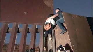 Migrants Climb Over Fence at USMexico Border [upl. by Halak]