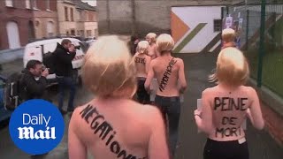 Femen protesters demonstrate as Marine Le Pen votes [upl. by Norwood]