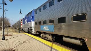 Metra 85 pulling metra 77 dead metra locomotive and meets fright train at lake forest [upl. by Ahsyt]