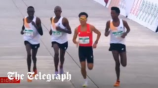 Runners appear to let Chinese contestant win Beijing halfmarathon [upl. by Bullard]