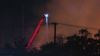 Fire crews in Texas battle pallet fire near Love Field Airport [upl. by Ahselef336]