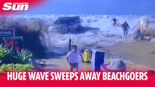 Huge wave washes beachgoers along the ground as several are injured [upl. by Tracey42]