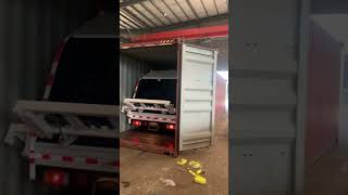 Isuzu ELF garbage compactor truck into 40HQ container [upl. by Essilem]