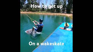 How to get up on a wakeskate wakeskating wakeboarding waterskiing beginners swimming [upl. by Akinehs]