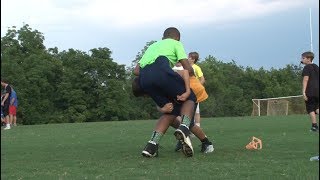 Rugbystyle tackling taught at local youth football leagues to reduce risk of concussions [upl. by Eeleimaj]