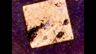 Gold plated sqares on ceramic CPU Sun 1996 Processor under microscope [upl. by Nemzaj]