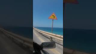 The road to Heraklion Crete winds through stunning beach views creteisland aegeancoast greece [upl. by Eibbob]