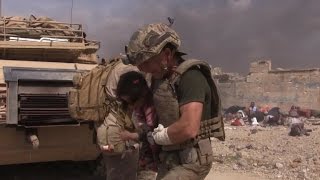 Dramatic video shows American aid worker rescuing Iraqi child [upl. by Adrell442]