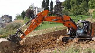 Doosan DX 235 LCR loading a truck and tidying up some dirt [upl. by Ahtabbat587]