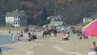 Beachgoers head to Hammonasset to enjoy unusually warm temperatures [upl. by Nemzzaj]